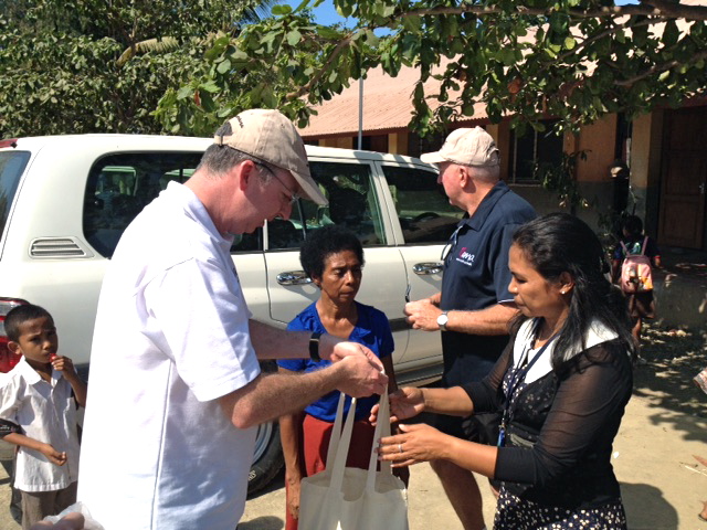 Mark Fraser handing over a sample of the art and craft supplies donated by MAMA to the Alola Foundation.